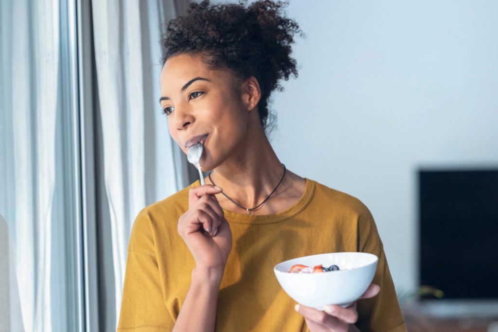 fibroid symptoms woman eating fruits with yogurt