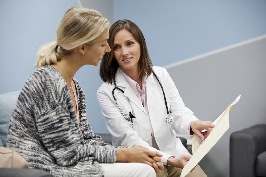 hysterectomy doctor visit showing medical report to patient ist695461876